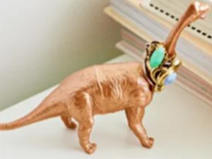 An old toy dinosaur repurposed as a ring holder